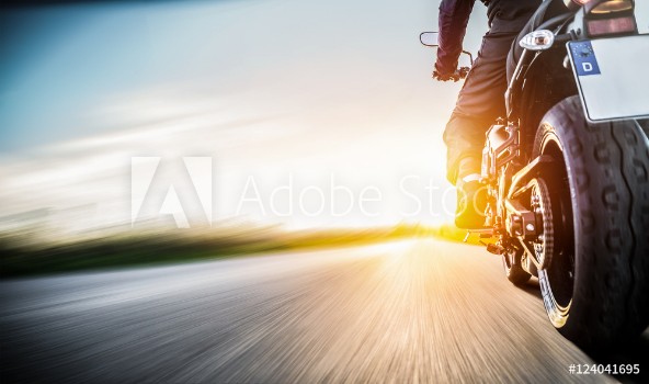 Picture of Motorrad fhrt auf freier Landstrasse in den Sonnenuntergang